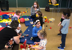 Children playing on the floor with toys