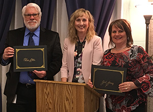 Staff receiving certificates commemorating 25 years of service