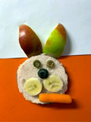 Bunny Sandwich 1 - Bunny face sandwich made from circle cut bread. Apple slices for ears, cheerio eyes, blueberry nose, banana slice cheeks.