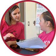 Teacher and student reading through the directions for a fun game