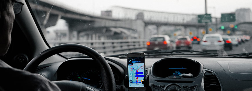 Driver looking at cell phone in traffic