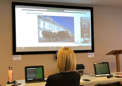 Staff in a classroom watching an online workshop