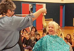 Student getting his hair cut.