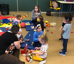 Children playing together on the floor with toys