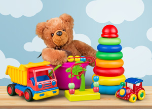 Children's toys including a dump truck, car, palm tree and a teddy bear sitting in a bucket