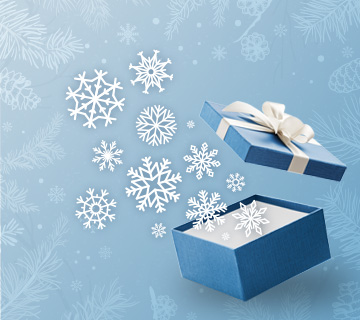 An open blue coloured giftbox with paper snowflakes coming up out of it against a winter background